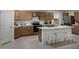 Modern kitchen featuring stainless steel appliances, an island with seating, and ample cabinet space at 18251 W Papago St, Goodyear, AZ 85338