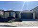 Single-story home with a two-car garage and desert landscaping at 19213 W Missouri Ave, Litchfield Park, AZ 85340