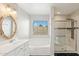 Bathroom with soaking tub, walk-in shower, and updated vanity at 19912 N Toledo Ave, Maricopa, AZ 85138