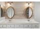 Double vanity bathroom with modern lighting and mirrors at 19912 N Toledo Ave, Maricopa, AZ 85138