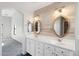 Double vanity bathroom with large mirrors and wood-look wall at 19912 N Toledo Ave, Maricopa, AZ 85138