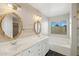 Bathroom with double vanity, large mirrors, and a soaking tub at 19912 N Toledo Ave, Maricopa, AZ 85138