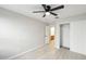 Bedroom with ceiling fan, closet, and access to bathroom at 19912 N Toledo Ave, Maricopa, AZ 85138