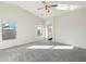 Spacious bedroom with carpeted floor and access to a patio at 19912 N Toledo Ave, Maricopa, AZ 85138