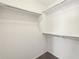 Spacious walk-in closet with double hanging rods and shelving at 19912 N Toledo Ave, Maricopa, AZ 85138