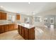 Kitchen with island, wood cabinets, and stainless steel appliances at 19912 N Toledo Ave, Maricopa, AZ 85138
