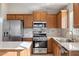 Modern kitchen with stainless steel appliances and wood cabinets at 19912 N Toledo Ave, Maricopa, AZ 85138