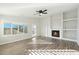 Spacious living room with fireplace, built-in shelving, and hardwood floors at 19912 N Toledo Ave, Maricopa, AZ 85138