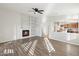 Spacious living room with fireplace, built-in shelving, and hardwood floors at 19912 N Toledo Ave, Maricopa, AZ 85138