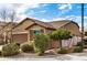 Tan house with two-car garage and lush landscaping at 22378 N 184Th Ln, Surprise, AZ 85387