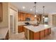 Kitchen with island, wood cabinets, and tile floor at 22378 N 184Th Ln, Surprise, AZ 85387