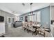 Bright dining area with a rustic wooden table and patterned chairs at 225 S 123Rd Dr, Avondale, AZ 85323