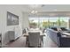 Bright dining room with large windows, a wooden table, and modern light fixture at 23386 N 73Rd Way, Scottsdale, AZ 85255