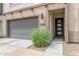 Modern home exterior with gray garage door and stylish front entrance at 23386 N 73Rd Way, Scottsdale, AZ 85255