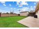 Large backyard with grassy area and concrete patio at 255 N Hunt E Dr, Mesa, AZ 85203