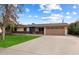Ranch style home with a two-car garage and well-manicured lawn at 255 N Hunt E Dr, Mesa, AZ 85203