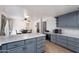 Eat-in kitchen with gray cabinets, island, and wood flooring at 255 N Hunt E Dr, Mesa, AZ 85203
