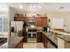 Well-equipped kitchen featuring granite counters and wood cabinets at 2725 E Mine Creek Rd # 1121, Phoenix, AZ 85024