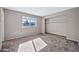 Well-lit bedroom, featuring neutral walls and carpeted floors, with a spacious closet at 2745 W Michelle Dr, Phoenix, AZ 85053