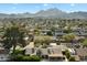 Aerial view of single-Gathering home with mountain views and lush landscaping at 2856 E Cochise Rd, Phoenix, AZ 85028