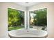 Relaxing bathroom with large soaking tub and window overlooking the backyard at 2856 E Cochise Rd, Phoenix, AZ 85028