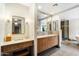 Modern bathroom with double vanity, large mirror and walk-in shower at 2856 E Cochise Rd, Phoenix, AZ 85028