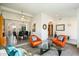 Living Room with orange armchairs, a glass coffee table and view into dining area at 2856 E Cochise Rd, Phoenix, AZ 85028