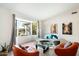 Living room featuring a curved sofa, large windows and mid century modern decor at 2856 E Cochise Rd, Phoenix, AZ 85028