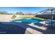 Relaxing kidney-shaped pool with patio furniture at 302 S Verdad Ln, Casa Grande, AZ 85194