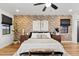 King sized bed in a spacious bedroom with brick wall at 36601 N Mule Train Rd # 1D, Carefree, AZ 85377