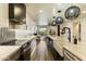 Modern kitchen with farmhouse sink, stainless steel appliances, and herringbone backsplash at 36601 N Mule Train Rd # D1, Carefree, AZ 85377