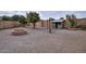 Large backyard with fire pit, fruit trees, and storage shed at 4648 S Emery --, Mesa, AZ 85212