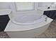 Bathroom with oval soaking tub and dark blue vanity at 4648 S Emery --, Mesa, AZ 85212