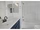 Clean bathroom with a navy vanity, tub, and tiled shower at 4648 S Emery --, Mesa, AZ 85212