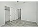 Bedroom with wood-look floors and access to another room at 4648 S Emery --, Mesa, AZ 85212