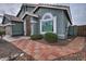 Home's entrance with a patterned walkway and landscaping at 4648 S Emery --, Mesa, AZ 85212