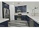 Modern kitchen with stainless steel appliances and dark blue cabinets at 4648 S Emery --, Mesa, AZ 85212