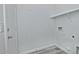 Bright laundry room with washer/dryer hookups and built-in shelving at 4648 S Emery --, Mesa, AZ 85212