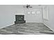 Living room with stone fireplace, wood-look floors, and ceiling fan at 4648 S Emery --, Mesa, AZ 85212