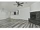 Open living room and kitchen with stone fireplace and wood-look floors at 4648 S Emery --, Mesa, AZ 85212