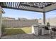 Outdoor kitchen with built-in grill and pergola, perfect for entertaining at 5116 N 185Th Ave, Litchfield Park, AZ 85340