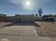 Front view of a tan house with a two-car garage at 5145 W Purdue Ave, Glendale, AZ 85302