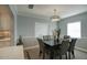 Dining area with a dark wood table, gray chairs, and light walls at 546 W Lewis Ave, Phoenix, AZ 85003