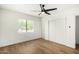 Well-lit bedroom with hardwood floors, ceiling fan and large closet at 5828 W Morten Ave, Glendale, AZ 85301