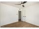 Spacious bedroom with hardwood floors, closet, and ceiling fan at 5828 W Morten Ave, Glendale, AZ 85301