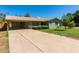 Front view of a ranch house with a carport and landscaped yard at 5828 W Morten Ave, Glendale, AZ 85301