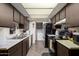 Clean galley kitchen with wood cabinets at 5984 W Augusta Ave, Glendale, AZ 85301