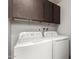 Laundry room with washer, dryer, and cabinets at 5984 W Augusta Ave, Glendale, AZ 85301