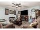 Living room with brown couches, coffee table, and fireplace at 5984 W Augusta Ave, Glendale, AZ 85301
