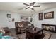Living room with brown couches, coffee table, and view into dining area at 5984 W Augusta Ave, Glendale, AZ 85301